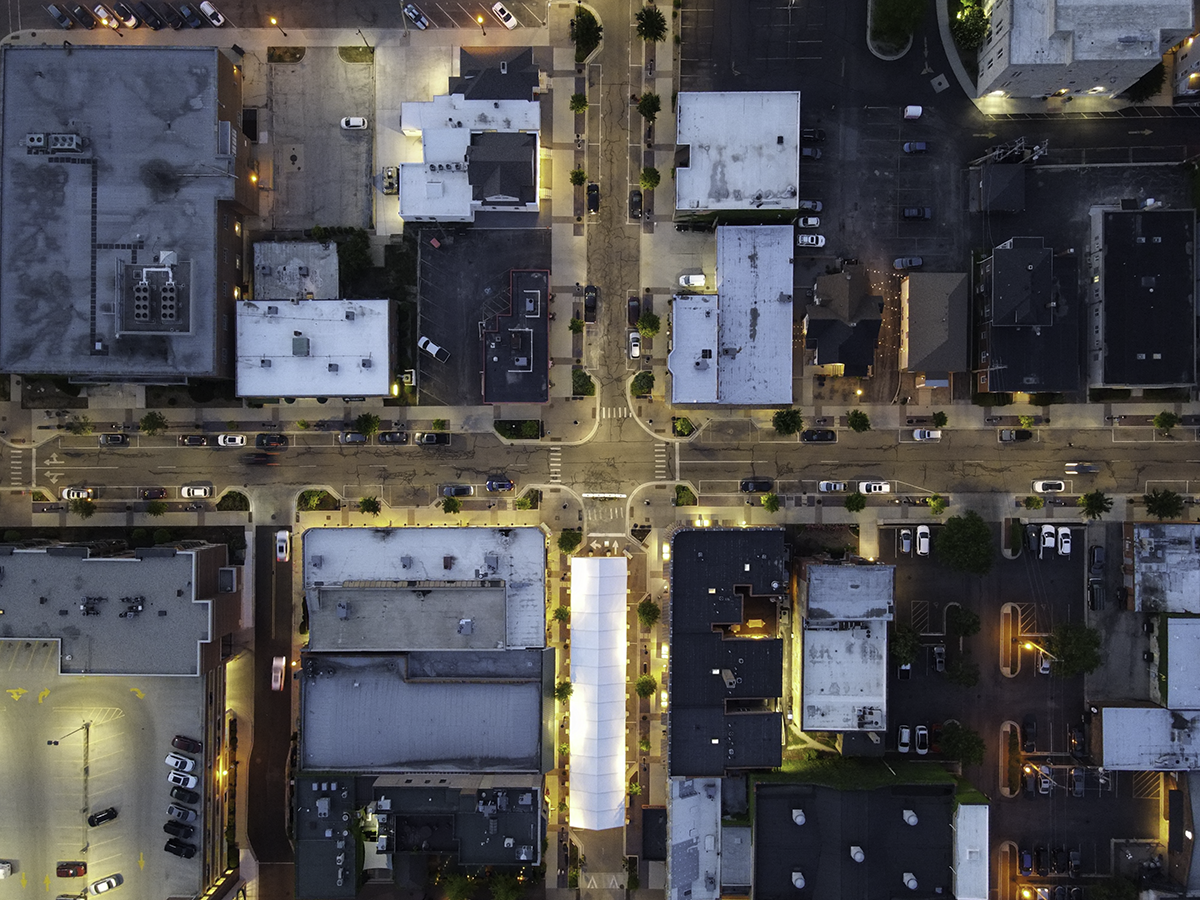 Commercial Inspection Services Aerial view of urban rooftops showing HVAC systems and infrastructure details for inspection.