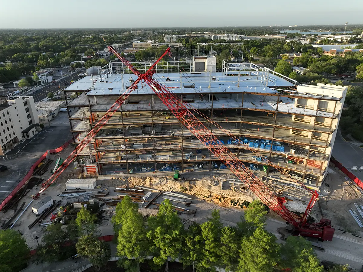 Commercial construction Site Progress Services Aerial view of a construction site with cranes in Orlando, Florida.